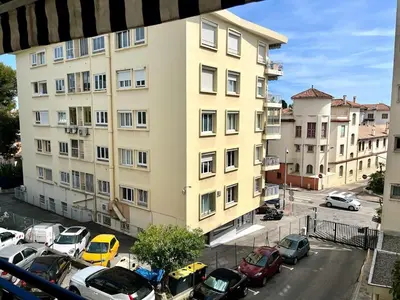 a large building with cars parked in a parking lot at Superbe appartement à Cannes / 3 chambres in Cannes