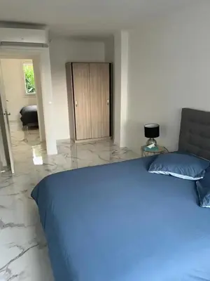 a bedroom with a bed with a blue blanket at Superbe appartement à Cannes / 3 chambres in Cannes