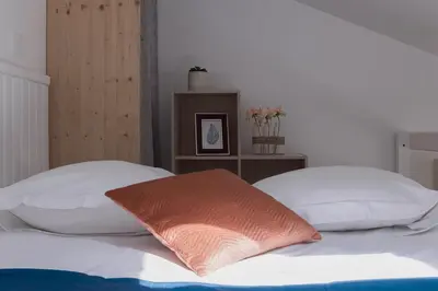 a bedroom with two white pillows on a bed at Studio André - Palais & plage, clim in Cannes