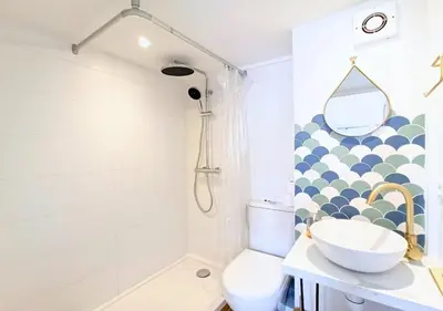a bathroom with a sink and a toilet and a shower at Studio André - Palais & plage, clim in Cannes