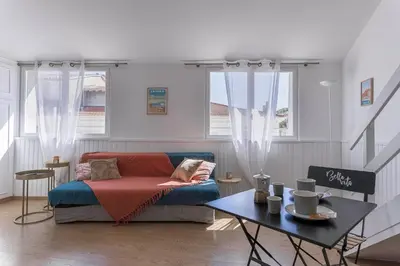 a living room with a couch and a table at Studio André - Palais & plage, clim in Cannes