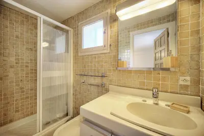 a bathroom with a sink and a shower and a toilet at Le Bel - Jardin - Parking - VCA in Cannes