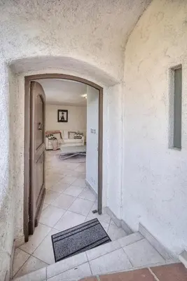 a hallway with a door and a living room at Le Bel - Jardin - Parking - VCA in Cannes