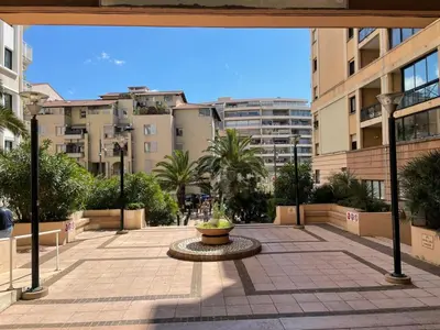 a view of a courtyard in a city with buildings at Résidence Palme d'Azur Cannes La Bocca in Cannes