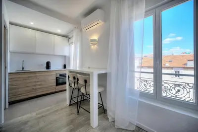 a living room with a couch and a table at Immogroom - Luminious T2 - Center - AC - Wifi in Cannes