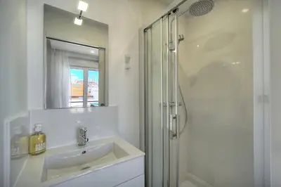 a living room with a couch and two tables at Immogroom - Luminious T2 - Center - AC - Wifi in Cannes