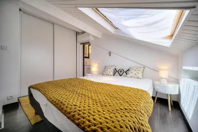 a living room with a table and chairs and a television at Immogroom - Luminious T2 - Center - AC - Wifi in Cannes