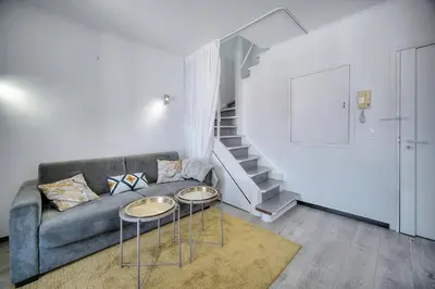 a kitchen with white cabinets and a sink and a window at Immogroom - Luminious T2 - Center - AC - Wifi in Cannes