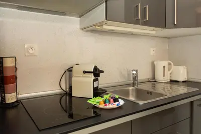 a kitchen counter with a sink and a mixer at Elegant 2 rooms in the heart of Cannes in Cannes