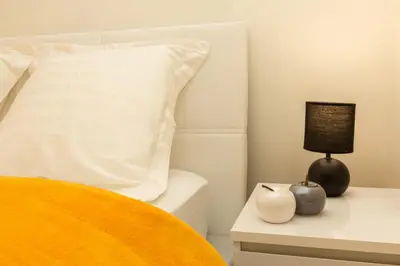 a bedroom with a bed with a pillow and a night stand at Elegant 2 rooms in the heart of Cannes in Cannes