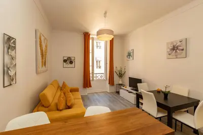 a living room with a couch and a table at Elegant 2 rooms in the heart of Cannes in Cannes