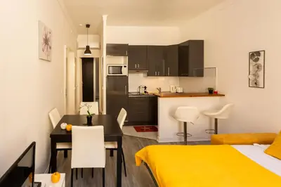 a small apartment with a kitchen and a dining room at Elegant 2 rooms in the heart of Cannes in Cannes