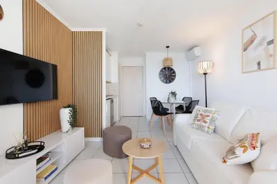 a living room with a white couch and a table at Holiday Paradise in Cannes