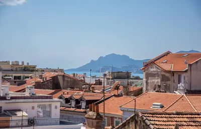 a view of roofs of buildings in a city at Le Mimosas - Studio Cannes centre - Vue mer Terrasse WIFI climatisation in Cannes