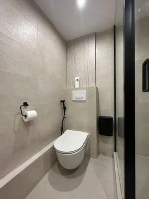 a bathroom with a white toilet in a stall at Appartement cannes centre à 3 minutes du palais des festivals in Cannes