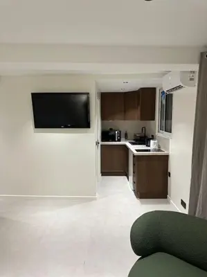 a kitchen with a flat screen tv on a wall at Appartement cannes centre à 3 minutes du palais des festivals in Cannes