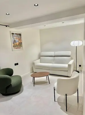 a living room with a couch and a table and chairs at Appartement cannes centre à 3 minutes du palais des festivals in Cannes