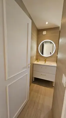 a bathroom with a sink and a mirror at La Dolce Vita de Cannes: Luxury city center apartement, beautiful View in Cannes