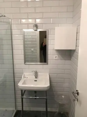 a person taking a picture of a bathroom sink at Croisette and beaches. View on gardens and sea. in Cannes