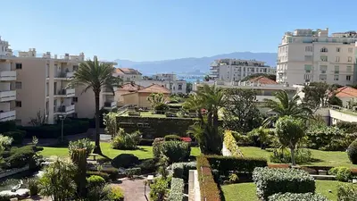 a view of a garden in a city with buildings at Croisette and beaches. View on gardens and sea. in Cannes