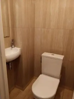 a bathroom with a white toilet and a sink at Croisette and beaches. View on gardens and sea. in Cannes