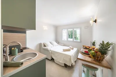 a bathroom with a sink and a bed in a room at Studio Banane 2 min croisette mitoyen Martinez in Cannes