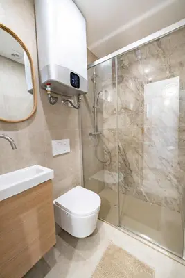 a bathroom with a shower and a toilet and a sink at Studio Banane 2 min croisette mitoyen Martinez in Cannes