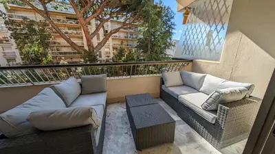 a balcony with two couches and a table at LACOUR7 Palmes dProperties in Cannes