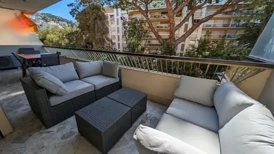 a balcony with two couches and a table at LACOUR7 Palmes dProperties in Cannes