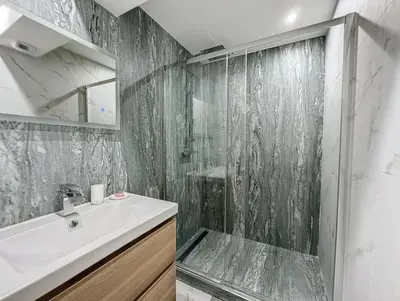 a bathroom with a shower and a sink and a mirror at Modern 2 Bedroom in the Heart of Cannes in Cannes