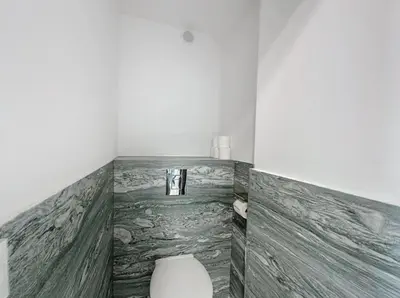 a bathroom with a toilet in the corner of a room at Modern 2 Bedroom in the Heart of Cannes in Cannes