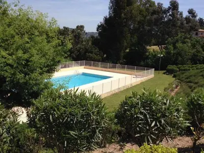a swimming pool in the middle of a yard at Hibiscus in Cannes