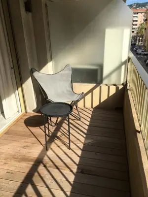 a chair sitting on a balcony with a table at center of cannes in Cannes