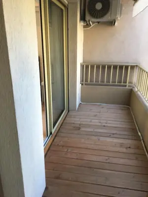 an empty hallway with a window and a fan at center of cannes in Cannes