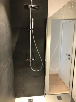 a shower with a glass door in a bathroom at center of cannes in Cannes