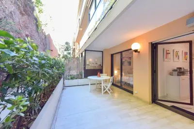 a balcony with a table and some plants at 1-Br apartment calm sea view pool and parking garage in Cannes