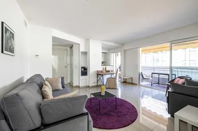 a living room with a couch and a table at Bright apartment near the Croisette - Cannes in Cannes