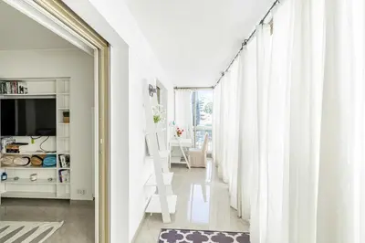 a room with white curtains and a sliding door at Bright apartment near the Croisette - Cannes in Cannes