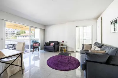 a living room with a couch and a table at Bright apartment near the Croisette - Cannes in Cannes