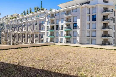a large building with a large yard in front of it at Bright apartment near the Croisette - Cannes in Cannes