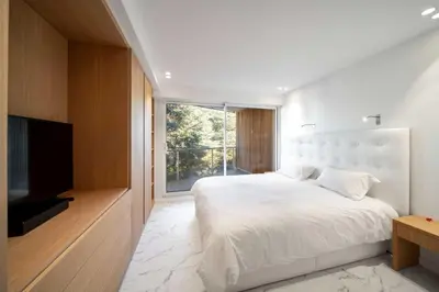 a bedroom with a large bed and a large window at Sumptuous terrace apartment - Cannes - Sea view in Cannes
