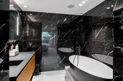 a black bathroom with a tub and a sink at Sumptuous terrace apartment - Cannes - Sea view in Cannes