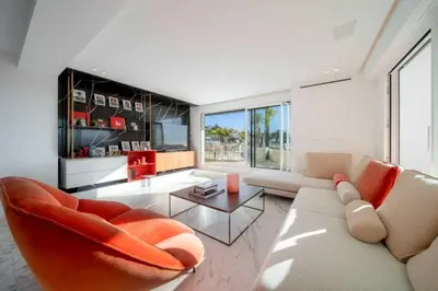 a living room with a couch and a table at Sumptuous terrace apartment - Cannes - Sea view in Cannes