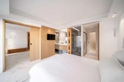 a bedroom with a white bed and a television at Sumptuous terrace apartment - Cannes - Sea view in Cannes