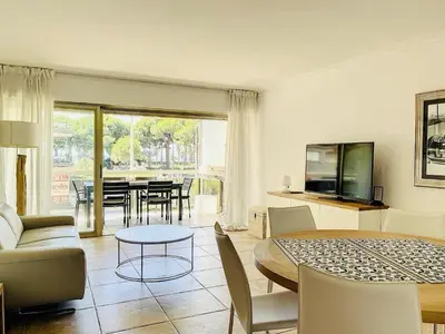 a living room with a table and a dining room at Cannes Palm Beach in Cannes