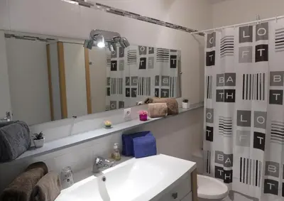 a bathroom with a sink and a mirror at Apartment Montmorency in Cannes