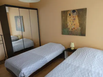 a bedroom with two beds and a painting on the wall at Apartment Montmorency in Cannes