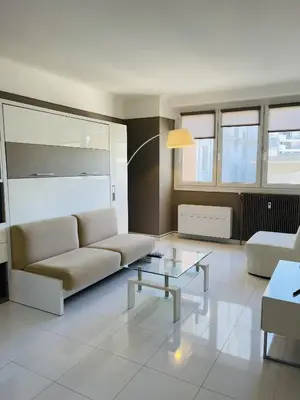 a living room with a couch and a table at Studio proche centre FARN4 in Cannes