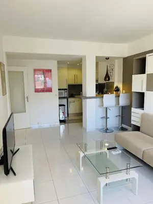 a living room with a couch and a glass table at Studio proche centre FARN4 in Cannes