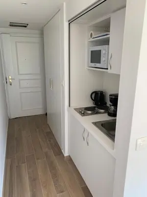 a small kitchen with a stove and a microwave at Studio Cannes bord de mer in Cannes